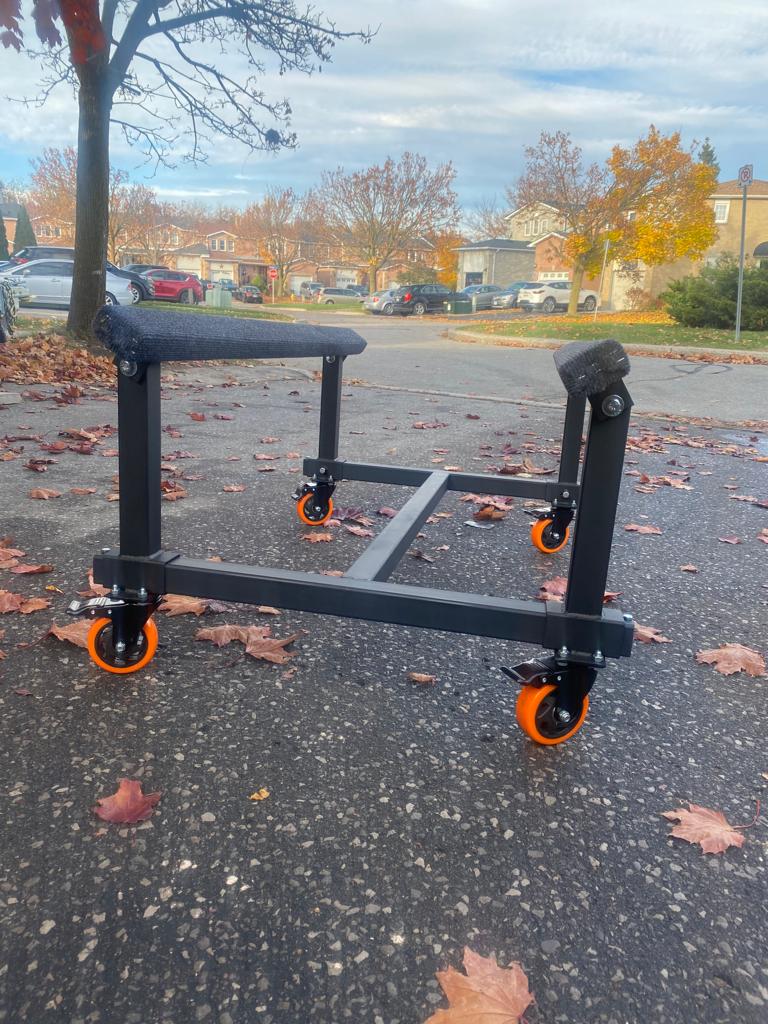 Watercraft PWC Dolly Boat Jet Ski Stand with vibrant orange wheels, a versatile and durable stand designed to transport and store personal watercraft. This dolly features sturdy construction and adjustable pads to securely hold the watercraft in place. Ideal for easy maneuvering and convenient storage of jet skis and other small boats.