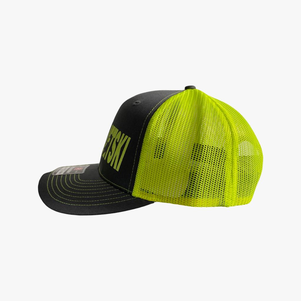 From the side, this sleek black hat reveals neon yellow mesh panels, providing both ventilation and a bold contrast to the classic black design. The 'Toronto Jet Ski' logo embroidered in vibrant pink on the front panel adds a stylish accent, while the adjustable snapback closure ensures a personalized fit. With its combination of practicality and urban flair, this hat is the perfect accessory for your watersport adventures.
