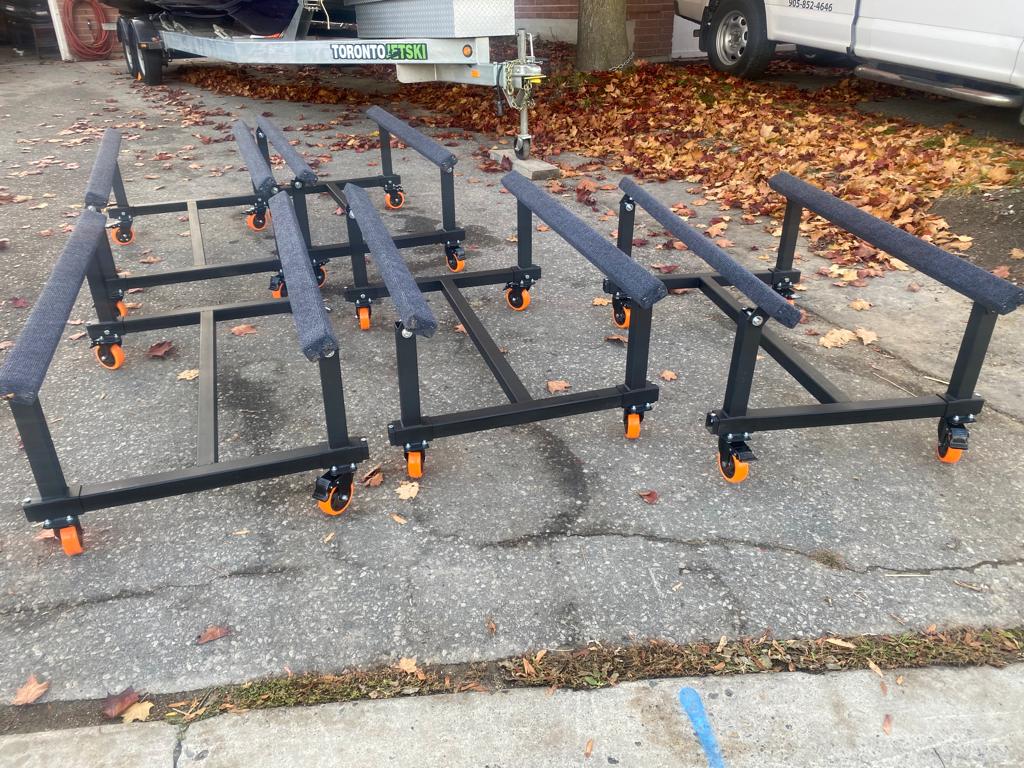 Image displaying five Watercraft PWC Dolly Boat Jet Ski Stands lined up in a row, showcasing their sturdy construction and versatility. Each stand is equipped with adjustable pads to securely hold personal watercraft, providing convenient storage and transportation solutions. Ideal for both individual watercraft owners and commercial applications, these stands offer efficient organization and space-saving capabilities.