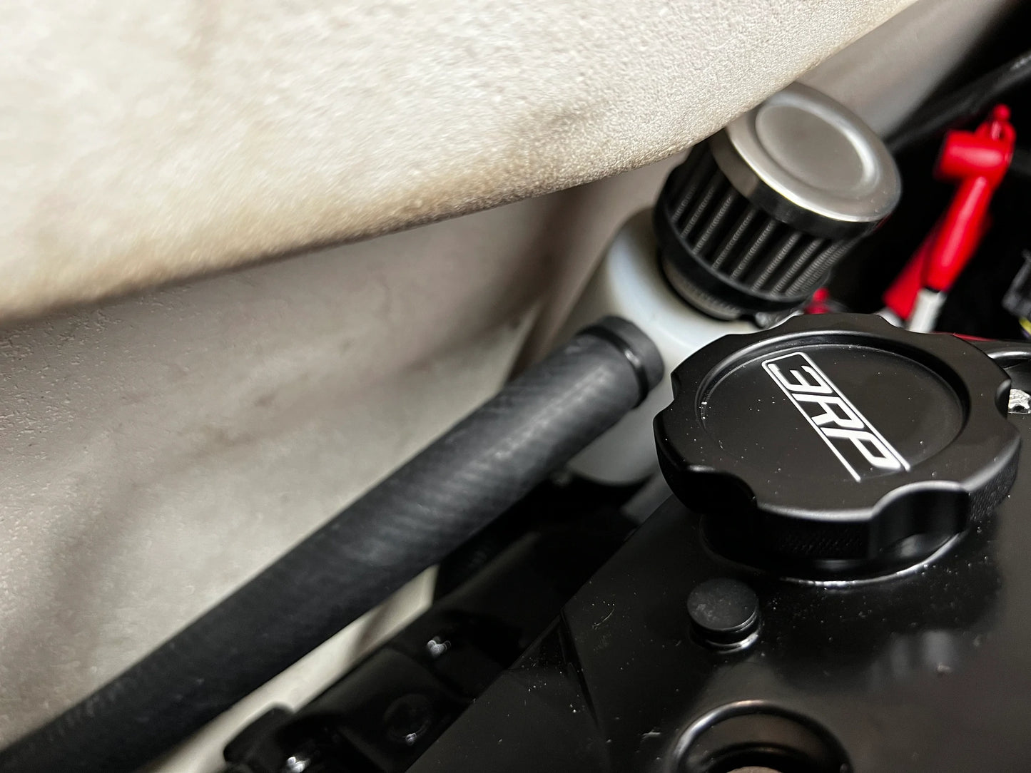 Sea-Doo Oil Catch Can Kit installed, demonstrating a perfect fit within the engine bay. The components are neatly arranged, showing the precision engineering and seamless integration with existing parts. The hoses and mounting hardware are securely fastened, highlighting the kit’s excellent compatibility and effectiveness in maintaining engine cleanliness.
