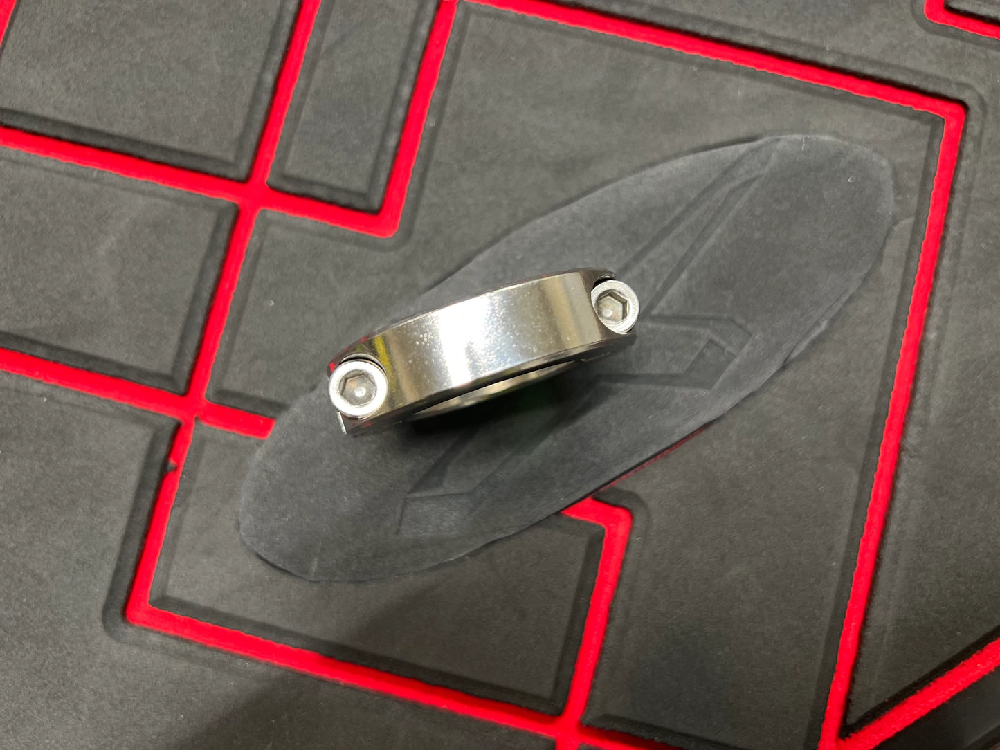 The ring that goes around the carbon seal and typically has a screw lock is commonly referred to as a "hose clamp" or "worm gear clamp." This clamp is used to secure the carbon seal reinforcement in place by tightening the screw, which adjusts the diameter of the clamp for a secure fit.