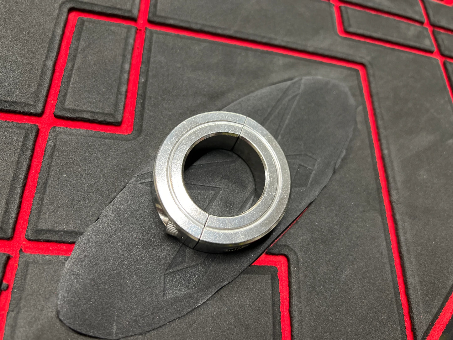 The ring that goes around the carbon seal and typically has a screw lock is commonly referred to as a "hose clamp" or "worm gear clamp." This clamp is used to secure the carbon seal reinforcement in place by tightening the screw, which adjusts the diameter of the clamp for a secure fit.