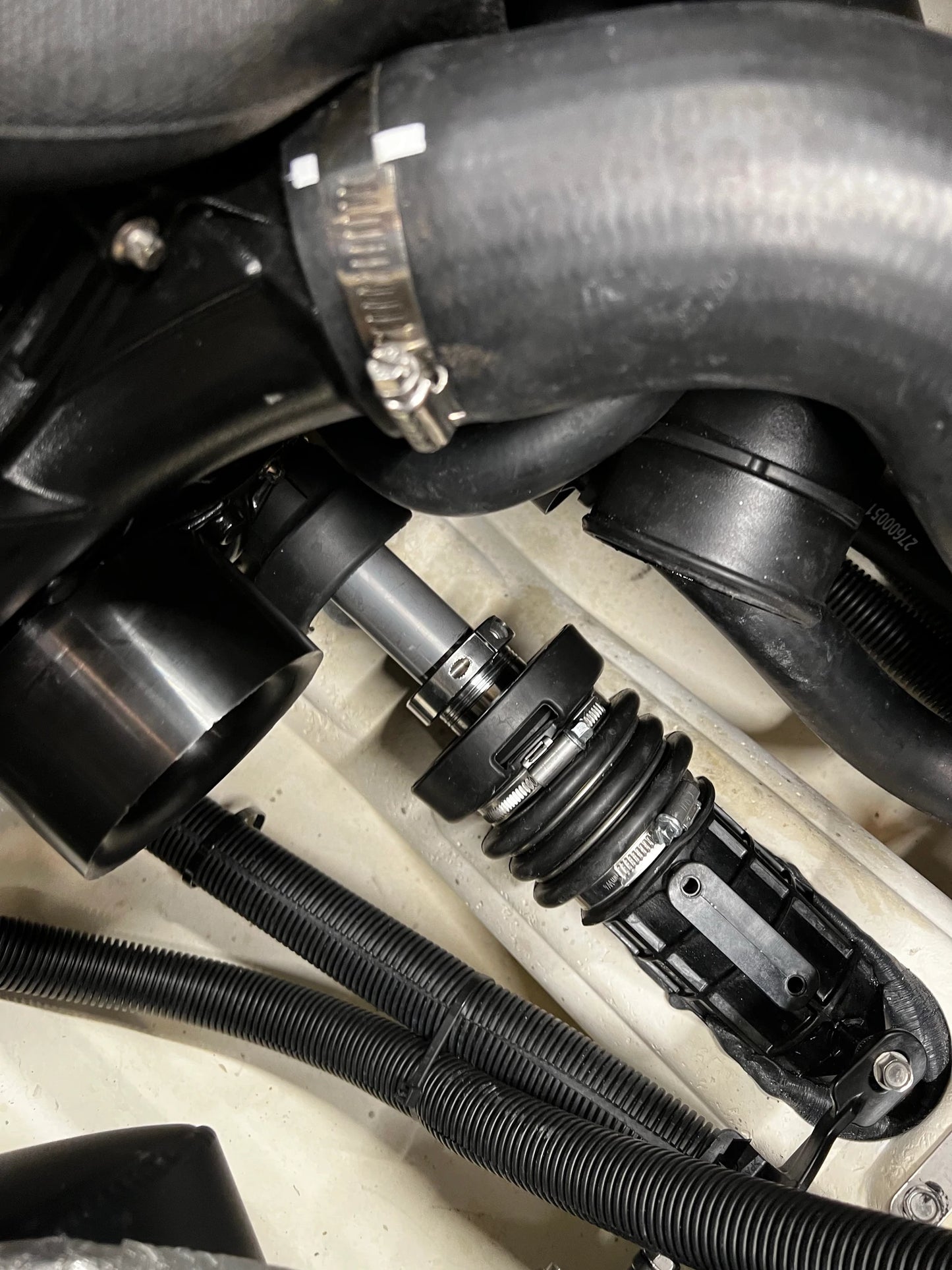 Installed Sea-Doo Carbon Seal Reinforcement Clamp, shown securely in place around the carbon seal. The clamp provides added support and stability, ensuring a snug fit and enhanced durability. The high-quality materials and precise engineering are evident, highlighting the clamp's role in maintaining optimal performance and preventing leaks in Sea-Doo watercraft.