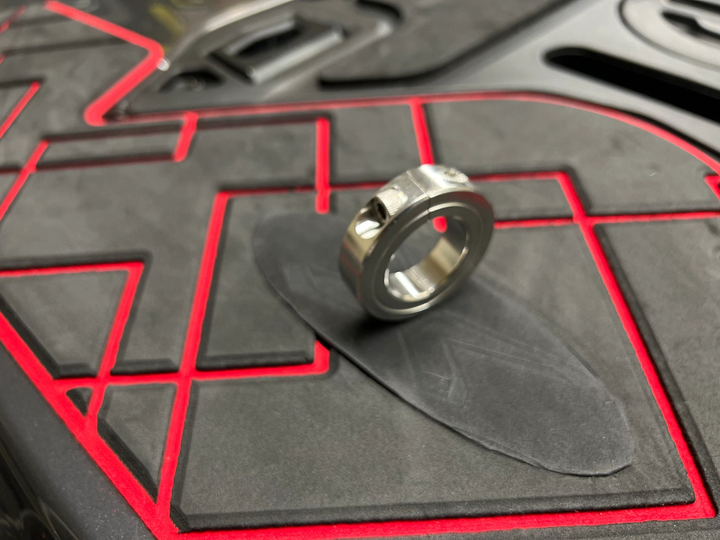 The ring that goes around the carbon seal and typically has a screw lock is commonly referred to as a "hose clamp" or "worm gear clamp." This clamp is used to secure the carbon seal reinforcement in place by tightening the screw, which adjusts the diameter of the clamp for a secure fit.