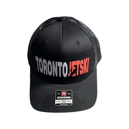 Toronto Jet Ski Snapback Trucker Hat in Black: This sleek black hat showcases the 'Toronto Jet Ski' logo embroidered in vibrant orange, adding a pop of color to its sophisticated design. The snapback closure ensures a comfortable fit for all-day wear, making it a stylish and practical accessory for your watersport adventures.