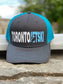 Toronto Jet Ski Trucker Hat: Front panel in sleek grey with white embroidered 'Toronto' and teal 'jetski' logo. Back features breathable teal mesh material. Teal stitching accents the brim, adding a coordinated touch to this stylish watersport accessory.
